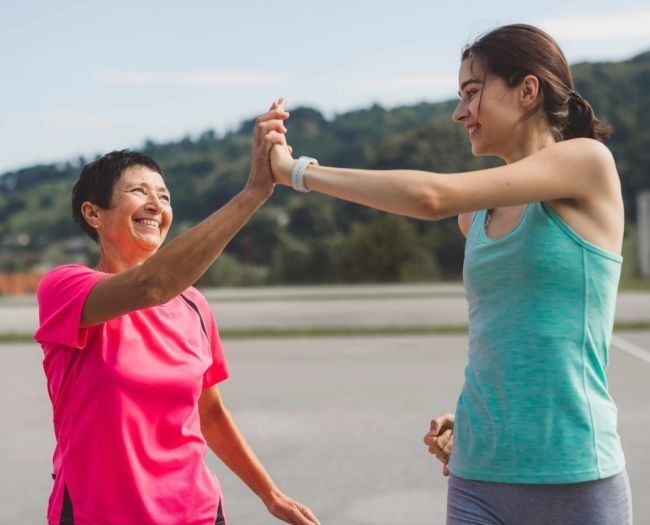 two-women-in-sportswear-clasping-hands.jpg